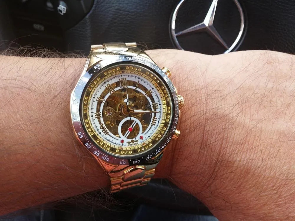 Winner mechanical sport skeleton watch with gold tones and red accents