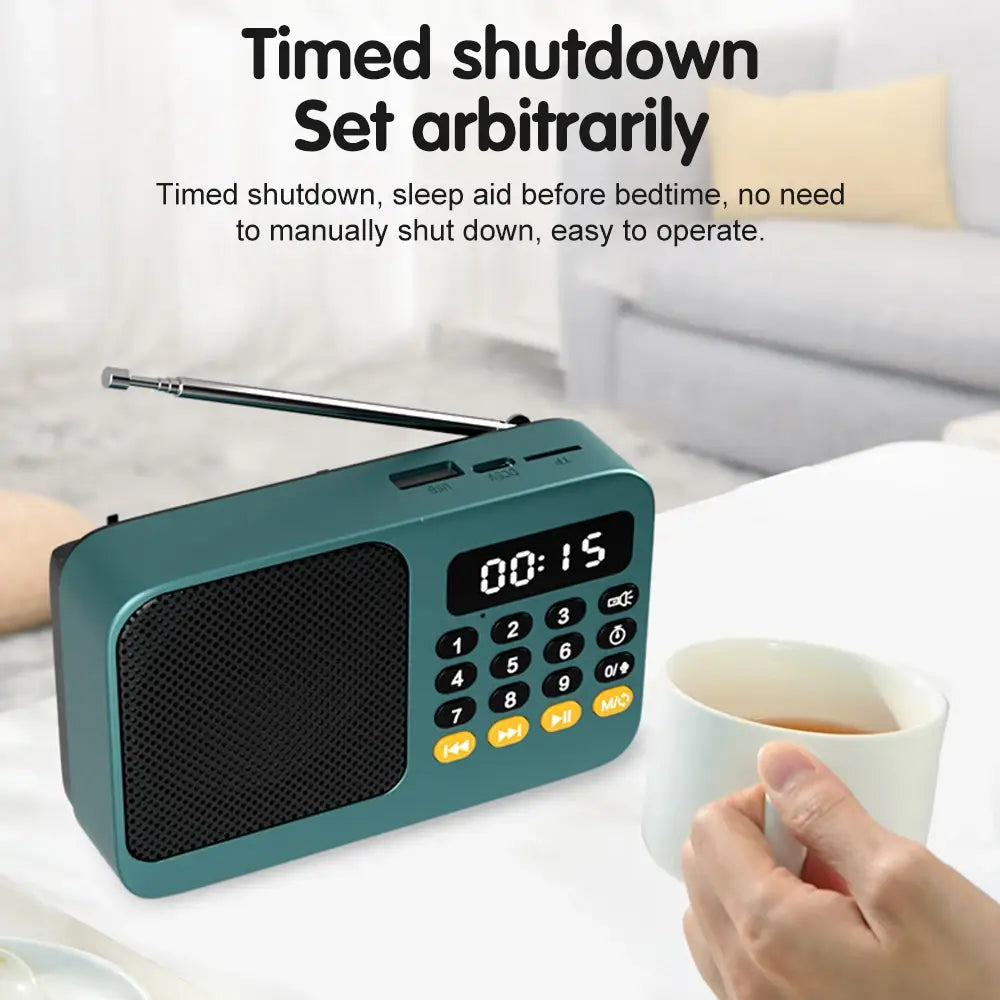 Teal portable radio music player with black grille, yellow buttons, antenna.